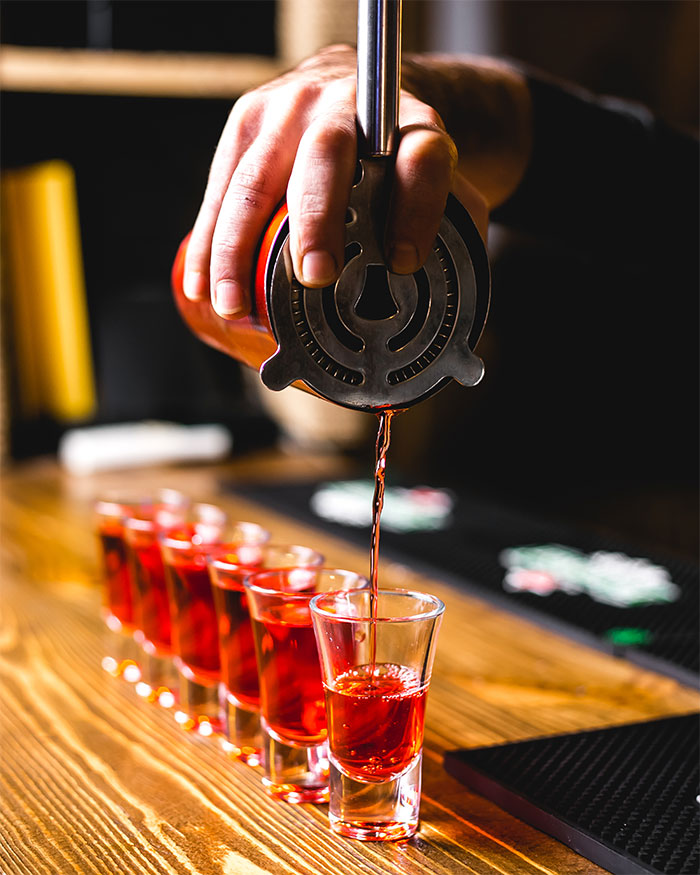 Hand finishing last shot in row of six