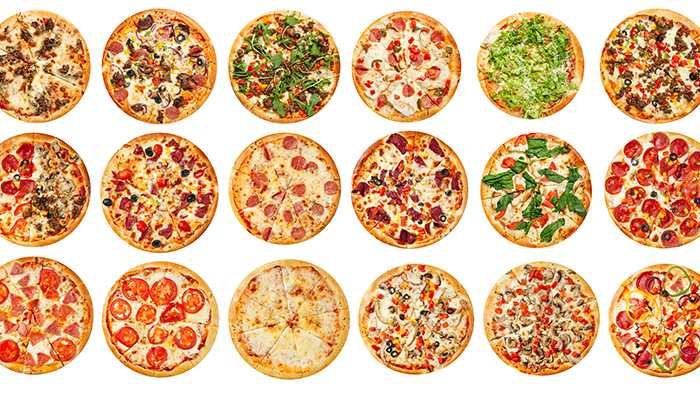 Three rows of six pizzas top down view