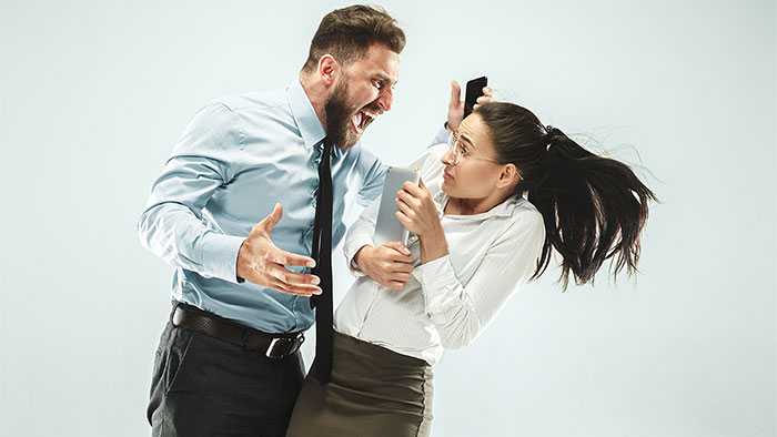 Stakeholder aggressively yelling down at defensive Scrum Master