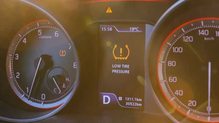 Dashboard with low tire pressure warning light on