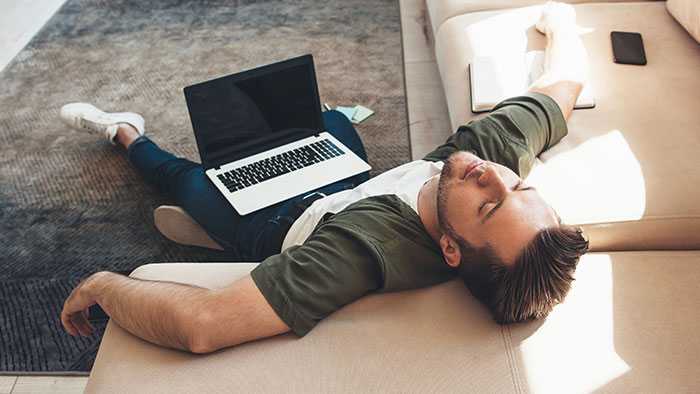 Dude napping in the sun with laptop