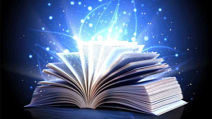 Magic aura flows over fanned pages of an open book
