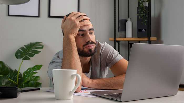 bored developer staring at laptop screen