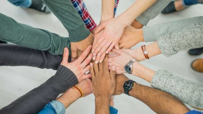 Pile of hands in a huddle