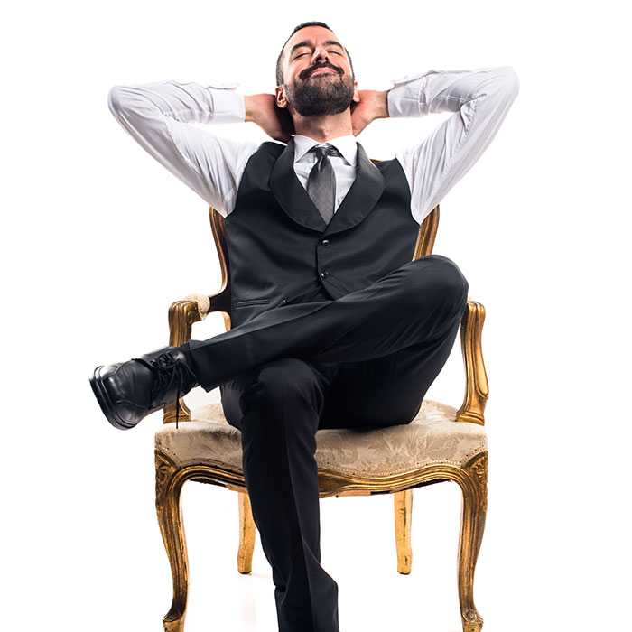 Suit wearing team member relaxes in comfy chair with no intention of leaving