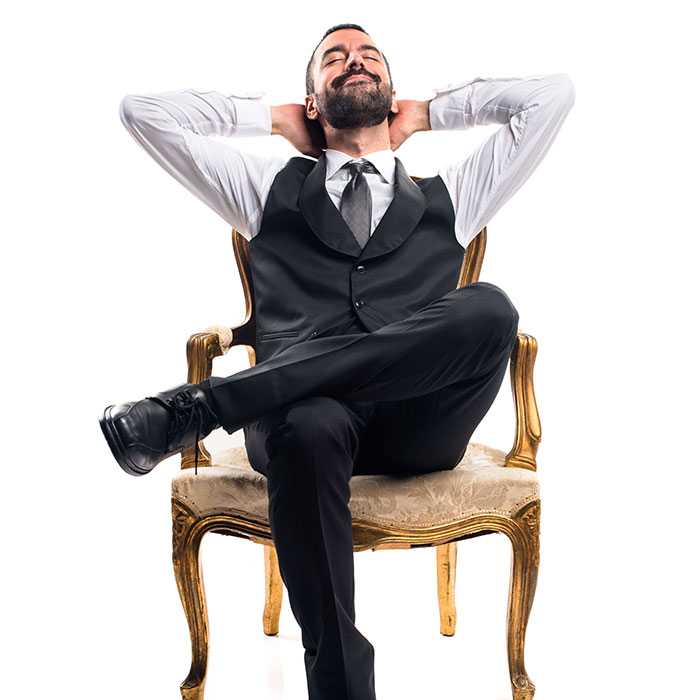 Suit wearing team member relaxes in comfy chair with no intention of leaving